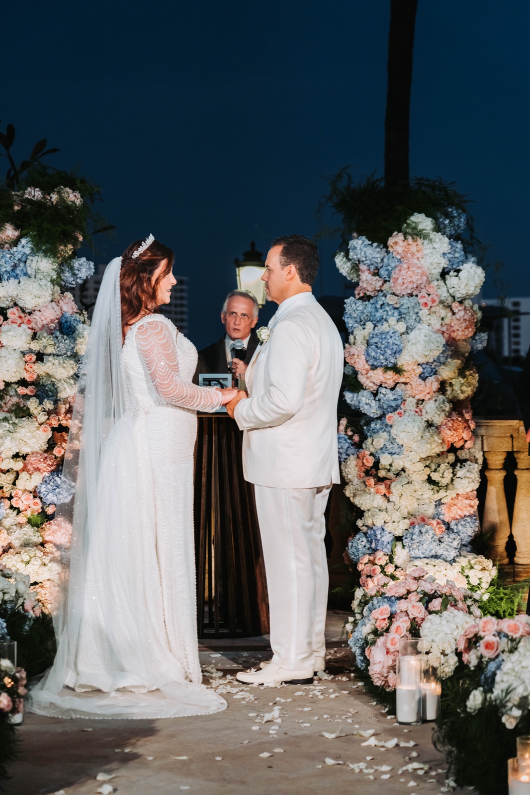 Vows beneath the floral ceremony arch
