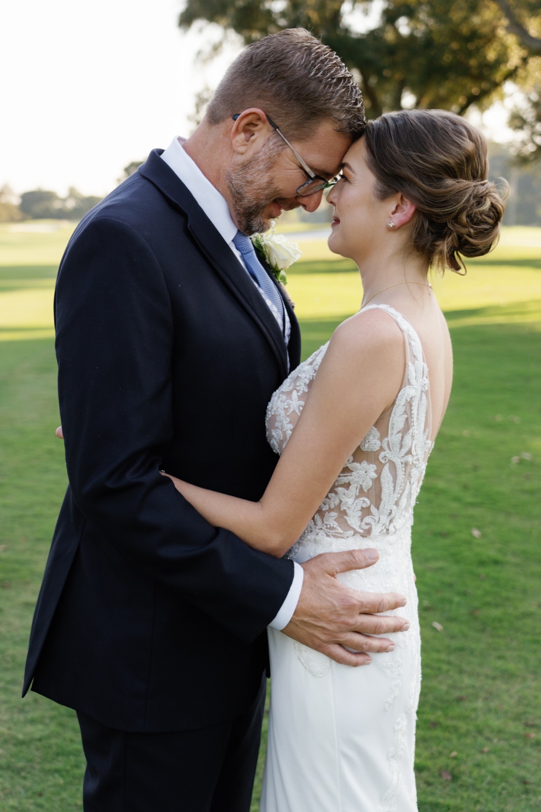 Couple embracing in golden light on the fairway