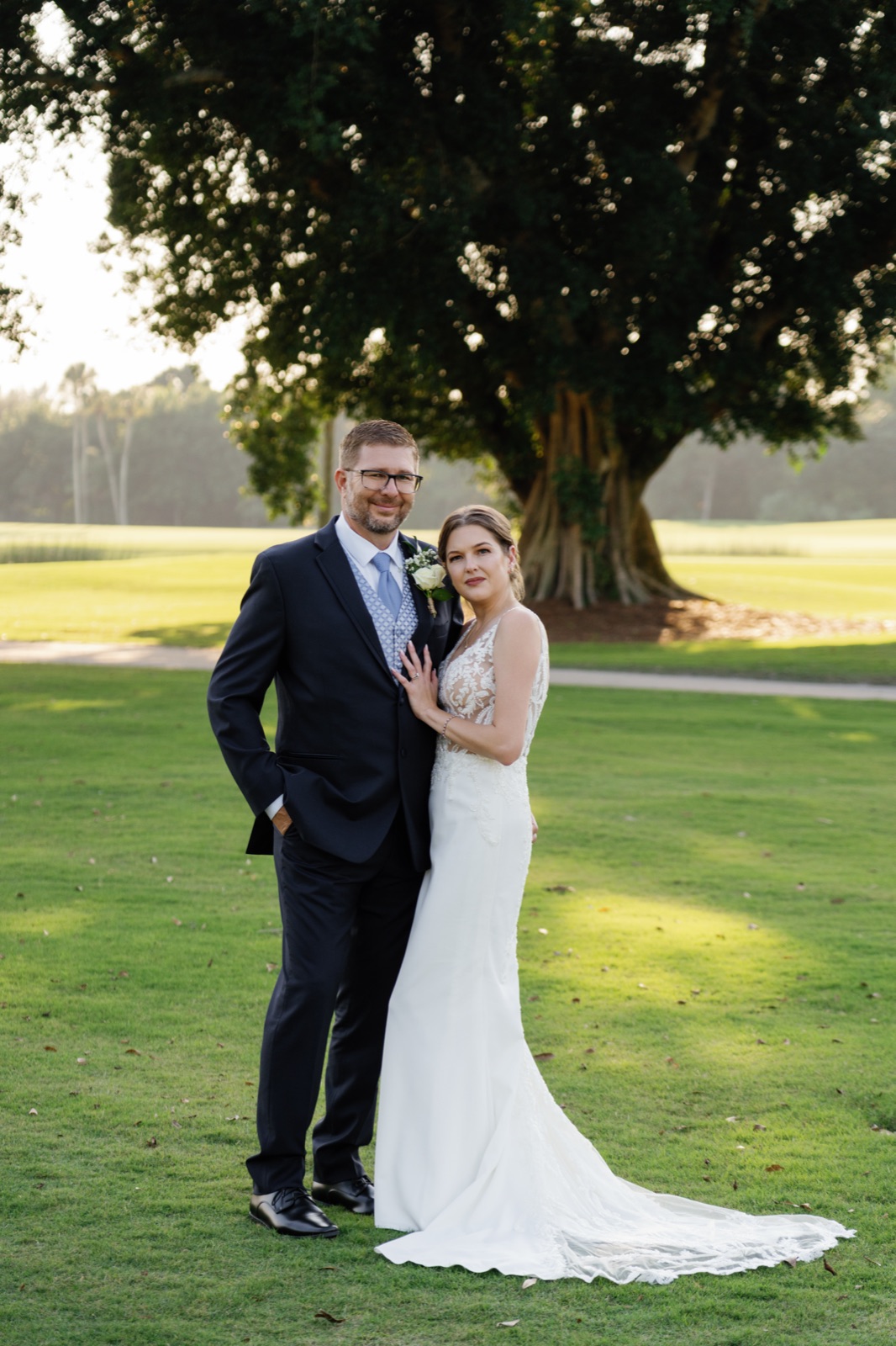 Bride and groom beneath a grand oak tree
