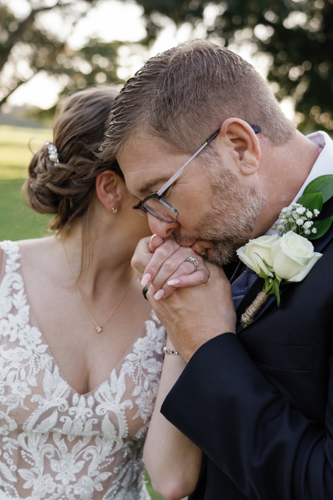 Groom kissing the bride's hand