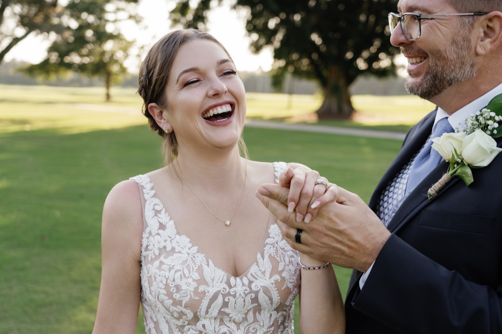 Bride laughing with her groom in golden light